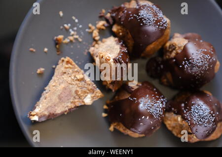 Anthill chocolate cake dessert on a gray plate. Black table in the kitchen. Bakery Stock Photo