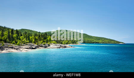 Scenic view of the forest across the beautiful Blue water of Lake Superior at Neys Provincial Park, Ontario, Canada Stock Photo