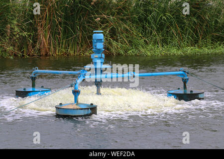 Water treatment by adding oxygen to the water using a propeller to hit the bubbles. Stock Photo