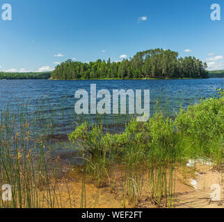View of an Island on French Lake from a sandy beach portage entry point at the Chippewa campground in Quetico Provincial Park, Atikokan, Ontario, Cana Stock Photo