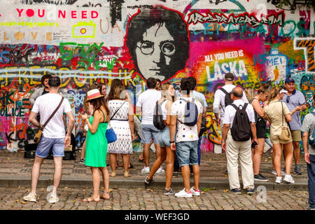 Tourists in front of John Lennon Wall Prague tourist Group of people city tour Prague Czech Republic Stock Photo