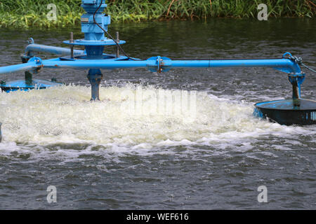 Water treatment by adding oxygen to the water using a propeller to hit the bubbles. Stock Photo