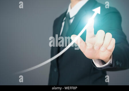 Businessman Hand Touching stock Graph Indicating Growth Stock Photo