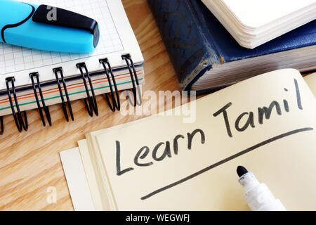 Notebook with sign Learn Tamil and pen. Stock Photo