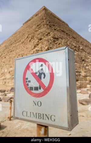 A sign forbidden to climbing. Out of focus the pyramid of khafre, Giza, Egypt Stock Photo
