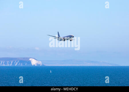 Bournemouth, Dorset UK. 30th August 2019. P-8A Poseidon Surveillance Aircraft - Boeing plane specifically developed for the US Navy and modified from the Boeing 737-800 does fly past at Bournemouth Air Festival with its wing span of nearly 40 meters, powered by two turbo fans. Showing the Isle of Wight and the Needles in the distance.  Credit: Carolyn Jenkins/Alamy Live News Stock Photo