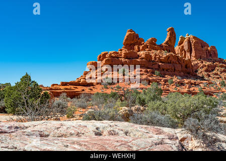 USA, Utah, Grand County, Arches National Park, Klondike Bluffs. A view of sandstone hoodoos and rock fins along Tower Arch hiking trail. Stock Photo