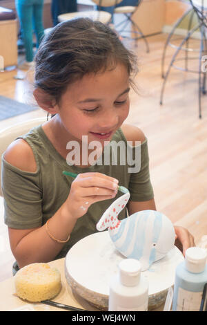 10 year old girl mixed ethnicity doing pottery, San Jose, California Stock Photo