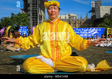 London, UK. 30th Aug 2019. Practitioners of the Chinese Falun Gong (also known as Falun Dafa) spiritual movement fill Parliament Square and surrounding areas and participate in a mass practice of their skills. Participants have come from all over Europe, including France, Germany, Italy and the UK, ahead of a conference in London tomorrow. Credit: Imageplotter/Alamy Live News Stock Photo