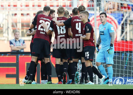 Nuremberg, Germany. 30th Aug, 2019. Soccer: 2nd Bundesliga, 1st FC Nuremberg - 1st FC Heidenheim, 5th matchday in Max Morlock Stadium. The players from Nuremberg cheer about their goal to 1:0. Credit: Daniel Karmann/dpa - IMPORTANT NOTE: In accordance with the requirements of the DFL Deutsche Fußball Liga or the DFB Deutscher Fußball-Bund, it is prohibited to use or have used photographs taken in the stadium and/or the match in the form of sequence images and/or video-like photo sequences./dpa/Alamy Live News Stock Photo