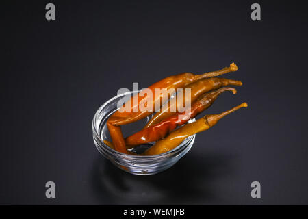 Marinated chilli pepper heap in the bowl Stock Photo