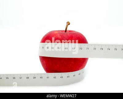 Red apple and yellow measuring tape to symbolize an healthy diet and body weight  control Stock Photo - Alamy