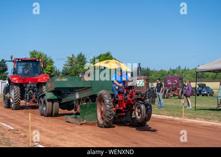 Dundas, Prince Edward Island / Canada - August, 25, 2019: Competitors with their tractors hauling a weighted sled in the annual tractor pull competito Stock Photo