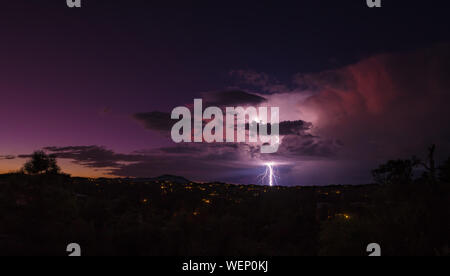 A late summer monsoon brings brilliant colors and dramatic lightning during the evening sunset. Stock Photo