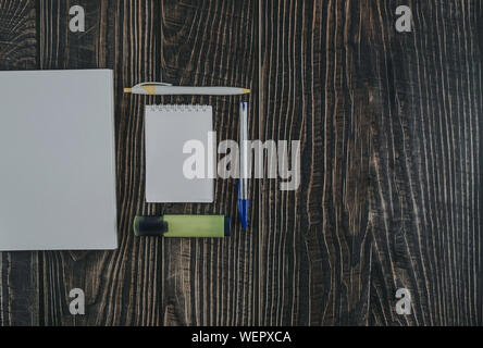 Open Travellers notebook with markers and pen on wood background, top view. back to school concept. Flat lay style with copy space Stock Photo