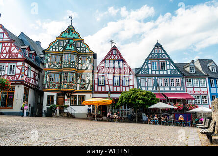 29 August 2019: Colorful Half-timbered (Fachwerkhaus) house, houses, cafe, restaurants, peaple on marketplace in Idstein, Hessen (Hesse), Germany. Nea