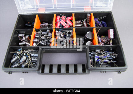 Electronic components capacitors stacked in a plastic folding case Stock Photo