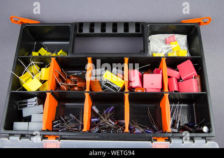 Electronic components capacitors stacked in a plastic folding case Stock Photo