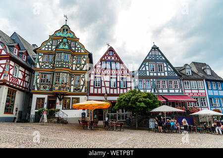 29 August 2019: Colorful Half-timbered (Fachwerkhaus) house, houses, cafe, restaurants, peaple on marketplace in Idstein, Hessen (Hesse), Germany. Nea