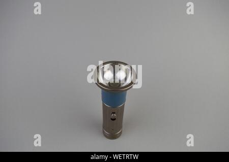 Pocket old flashlight on a gray background with a place to fill text Stock Photo