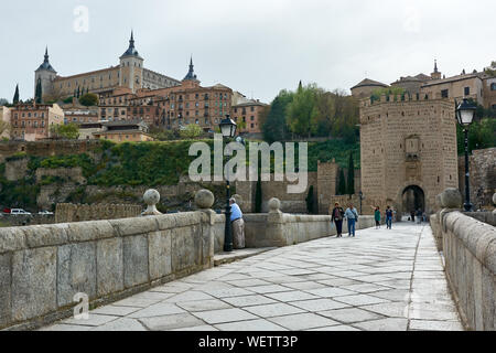 TOLEDO, SPAIN - APRIL 24, 2018: View of the Alcantara Bridge and the Alcazar of Toledo. Stock Photo