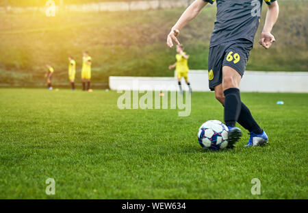 close - up of a football player with a ball on the field Stock Photo