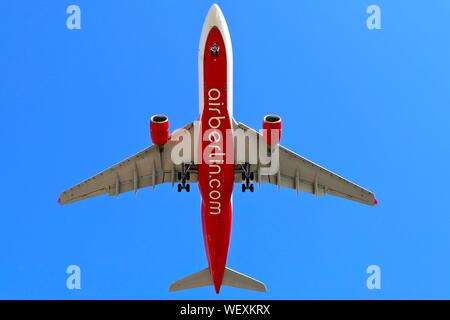 An Air Berlin Airbus A330 on final approach with its wheels down against a blue sky Stock Photo