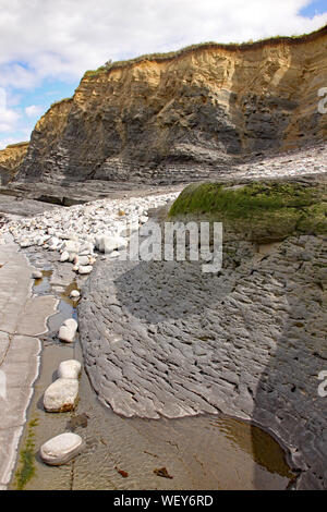 Rocks on Kilve beach near East Quantoxhead in Somerset, England. Stratified layers of rock date back to the Jurassic era and are a paradise for fossil Stock Photo