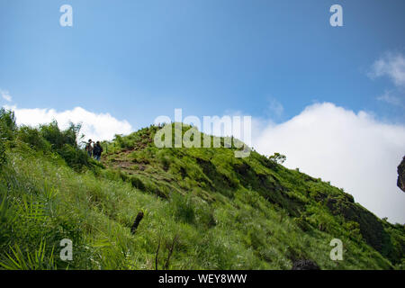 Great green mountain ranges. Peaks surrounded by green plants and a blue sky background. Very similar to the ones found in Himalayas and Western Ghats Stock Photo