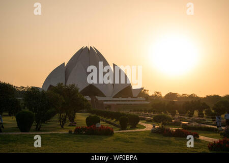 Lotus temple with the sun setting down in the background Stock Photo