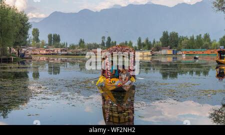 A couple of boys fishing in Dal Lake, Srinagar on a late afternoon. Stock Photo