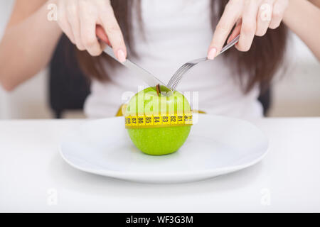 Diet. Apple and centimeter on the plate. Fitness healthy eating Stock Photo