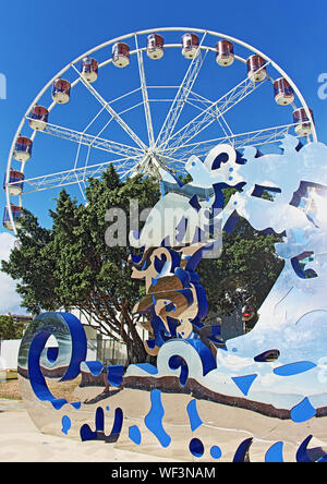 The Reef Eye ferris wheel ride attraction on the waterfront provides a scenic view over Trinity Inlet, the estuary, the Esplanade and Cairns City Stock Photo