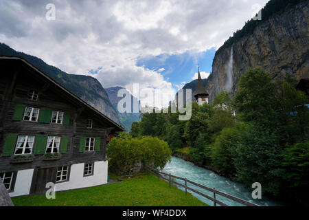 Church and Staubbach Falls in the Swiss Town of Lauterbrunnen, Bernese Oberland, Switzerland Stock Photo