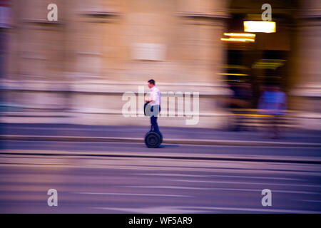 Man riding Segway along a street in Vienna Austria. Stock Photo