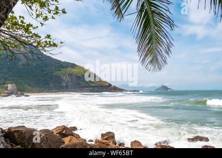 Landscape at Prainha Beach, Rio de Janeiro, on a windy day with the sea full of waves Stock Photo