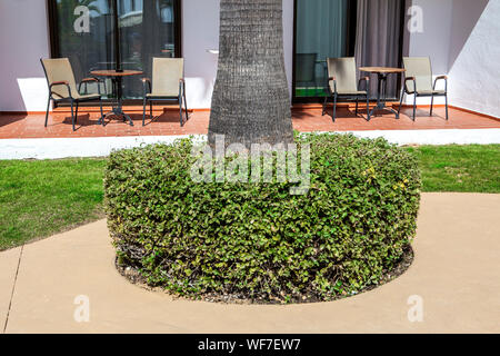 Empty Chairs On Porch Against House