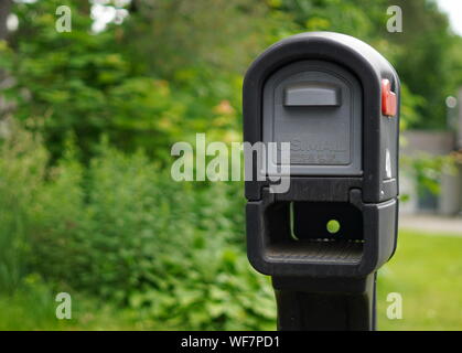 Cromwell, CT / USA - June 7, 2019: Black and grey plastic mailbox in a residential area Stock Photo