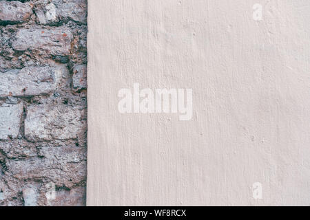Beige new painted plastered wall with old brick wall background Stock Photo