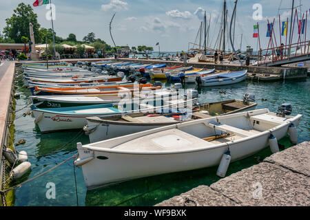 Bardolino, Italy - July 27, 2019: Fishing boats moored up in Bardolino harbour on Lake Garda Stock Photo