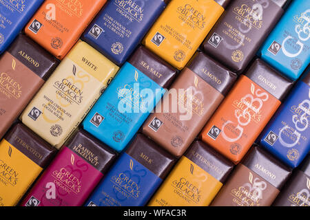 Green & Blacks organic chocolate bars background. A patchwork of different bars in a variety of flavours and colours. Stock Photo