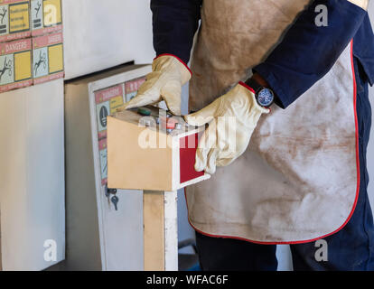 worker operating a Rolling Machine in an african workshop Stock Photo