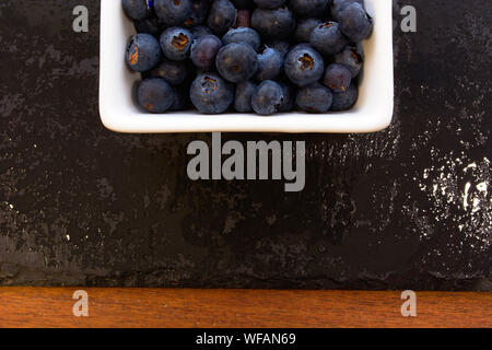 Blueberries on slate and wood