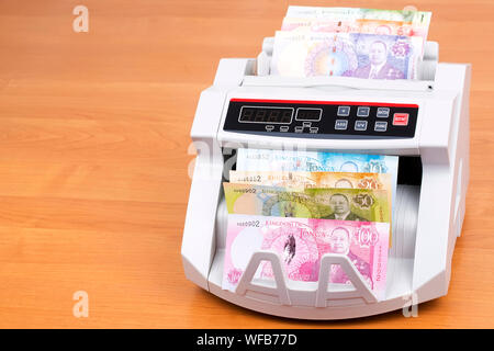 Tongan money in a counting machine Stock Photo