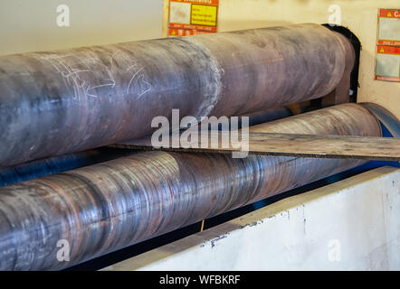 worker operating a Rolling Machine in a Botswana workshop Stock Photo