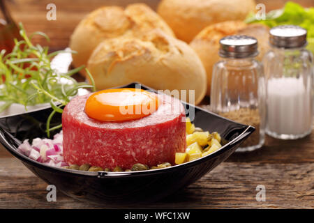 Beef tatare with egg, onion, cucumber and capers Stock Photo