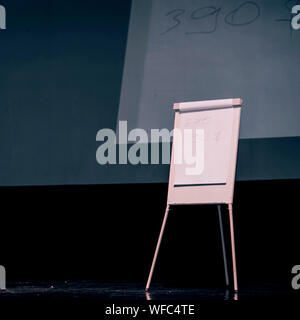 podium of the seminar with a flip chart and a large screen . photo with a copy of the space. Stock Photo