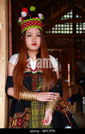 Beautiful Kuki tribes lady in front of their traditional house at Hornbill Festival, Nagaland Stock Photo