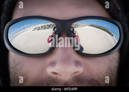 Cropped Image Of Man With Woman At Beach Reflection In Sunglasses