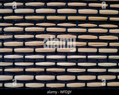 Bamboo woven with black fabric, textured surface Stock Photo